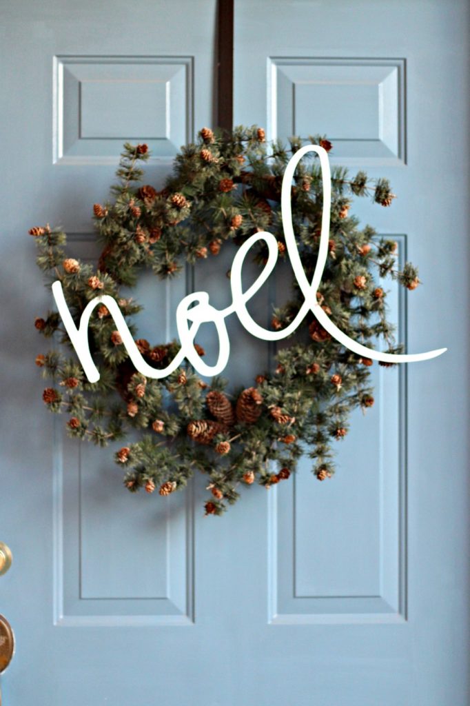 Noel wreath on front porch
